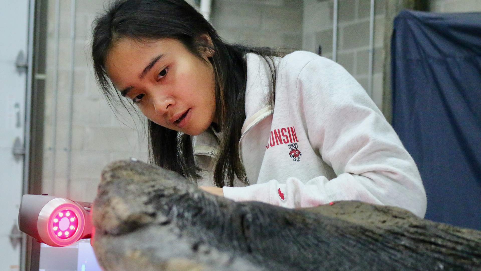 Ho-Chunk youth examines the canoe during the 3D scan.